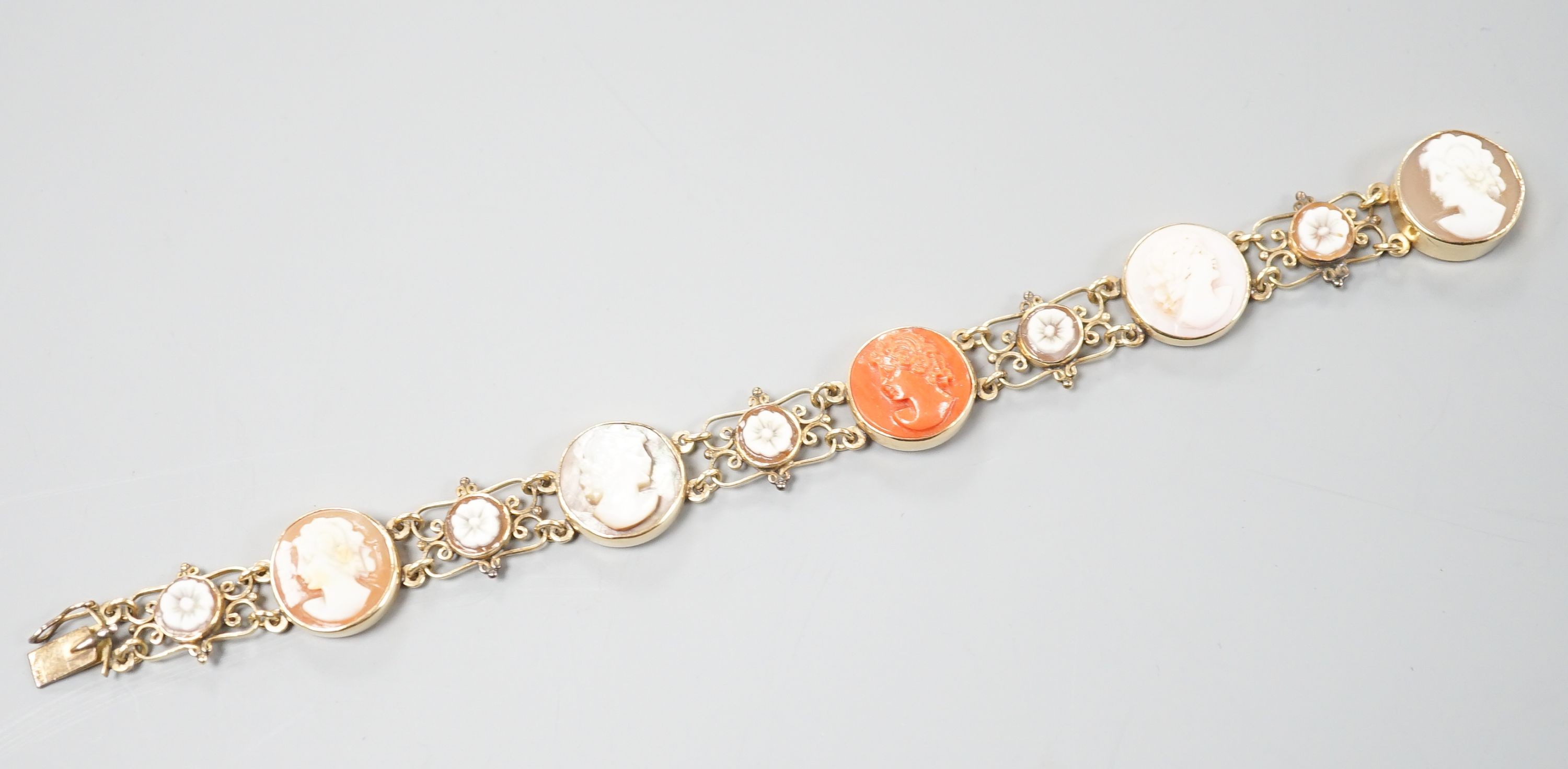 A 14k yellow metal gold Neapolitan shell and coral cameo set bracelet, 16.3cm, gross weight 13.4 grams.